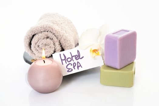 Spa and wellness setting with natural soap, candles and towel. Beige dayspa