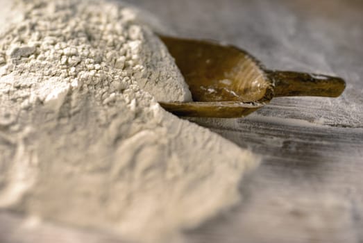 Whole grain flour heap tillt shift on a baking table
