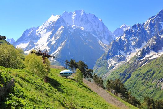 Image of landscape with Caucasus mountains and UFO