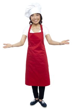 I welcome you my guests. Asian female chef posing with arms wide spread, grand welcome.