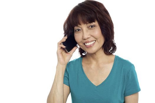 Pretty woman communicating on phone isolated against white background