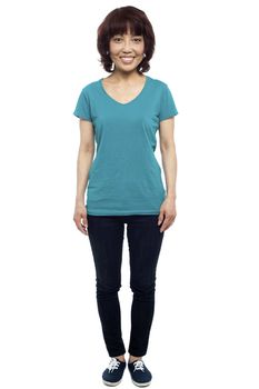 Isolated smiling pretty woman in attention position, dressed casually