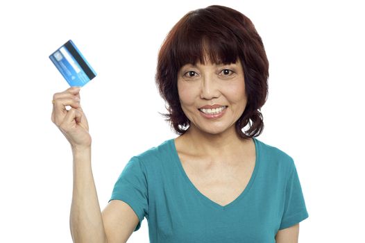 Beautiful woman holding her credit card out isolated over white