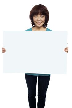 Woman holding billboard, your ad here. Isolated on white