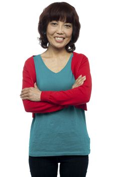 Beautiful asian woman posing with her arms crossed isolated over white