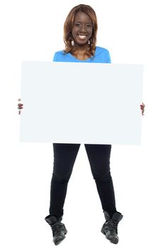 African girl model holding blank billboard. Full length shot