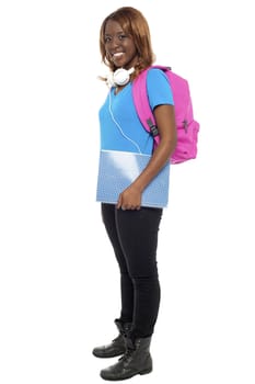 Full length portrait of trendy musical college girl isolated over white background