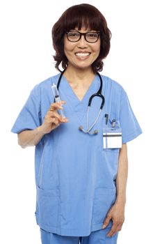 Experienced female pediatrician ready with a syringe. Isolated on white