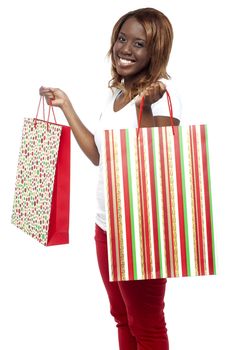Woman carrying shopping bags. She grabbed great discounts from sale on purchases