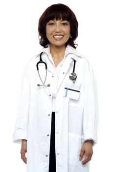 Experienced female doctor with stethoscope around her neck. Isolated and smiling