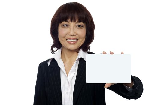 Isolated smiling asian business lady showing blank placard to camera