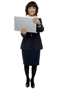 Full length portrait of business representative holding laptop
