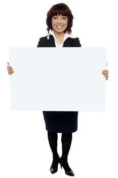 Isolated experienced asian businesswoman holding blank white billboard