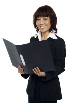 Secretary holding opened binder, smiling. Isolated against white background