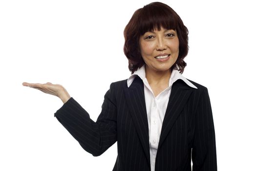 Asian business lady presenting copy space. Looking at camera