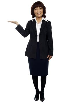 Businesswoman presenting copy space isolated over white. Full length shot