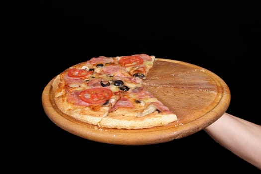 Pizza and slice of pizza in hand