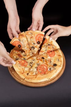 A group of people taking slices of pizza