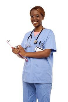 Female surgeon writing medical prescription. Looking at you