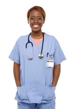 Relaxed female surgeon posing with hands in her coat isolated over white background