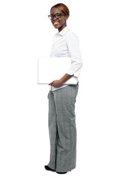 Full length shot of businesswoman with laptop isolated over white