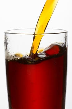 drink poured into a glass over white background