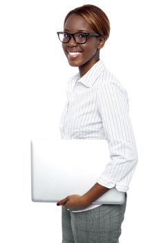 Side view of cheerful business consultant carrying laptop isolated against white background