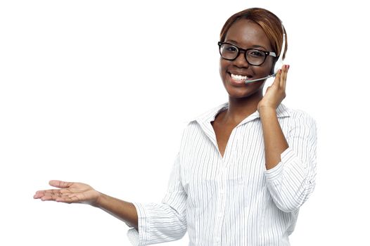 Customer service representative attending calls. Making gestures with hand while explaining it to client