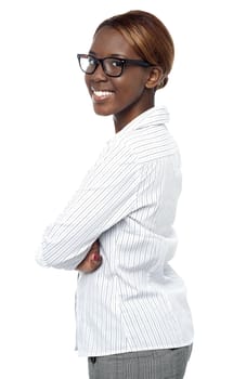 Isolated african business executive smiling with crossed arms. Side view