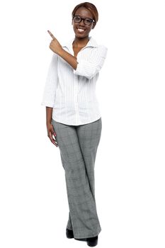 African female secretary pointing at copy space. Full length portrait