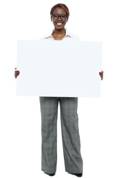 Full length portrait of corporate woman holding blank white billboard