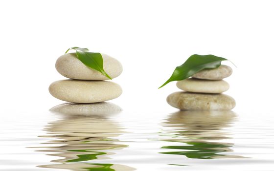 Spa stones and green leaf, isolated on white background.