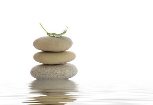 Spa stones and green leaf, isolated on white background.