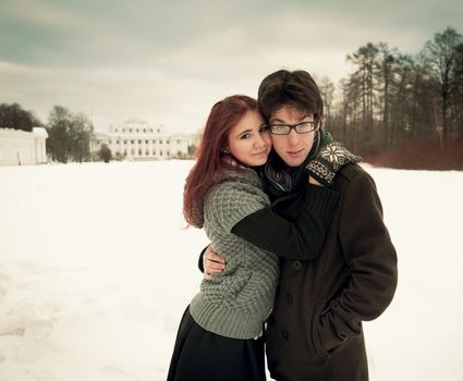 man and woman embracing in winter