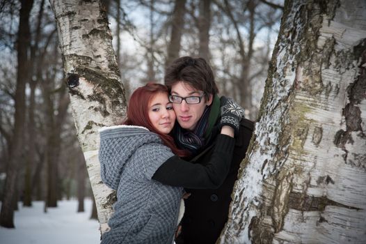 man and woman embracing in winter