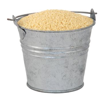 Cous cous in a miniature metal bucket, isolated on a white background