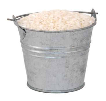 White long grain rice in a miniature metal bucket, isolated on a white background