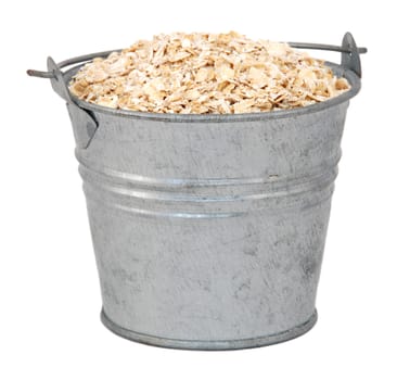 Porridge oats in a miniature metal bucket, isolated on a white background