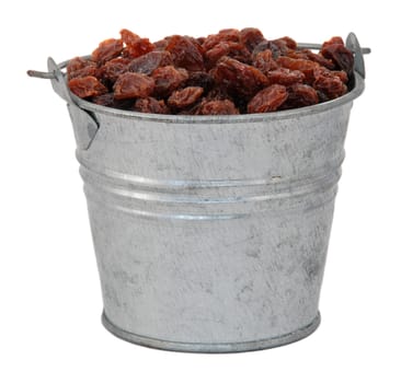 Raisins in a miniature metal bucket, isolated on a white background