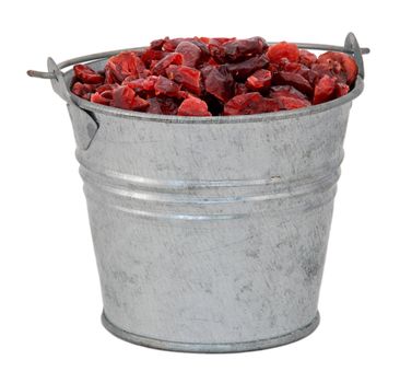 Dried cranberries in a miniature metal bucket, isolated on a white background