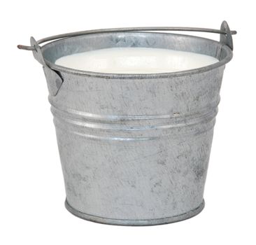 Milk in a miniature metal bucket, isolated on a white background