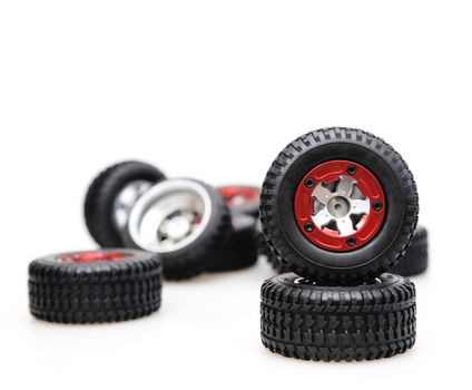 Rubber tires on red rims on a white background
