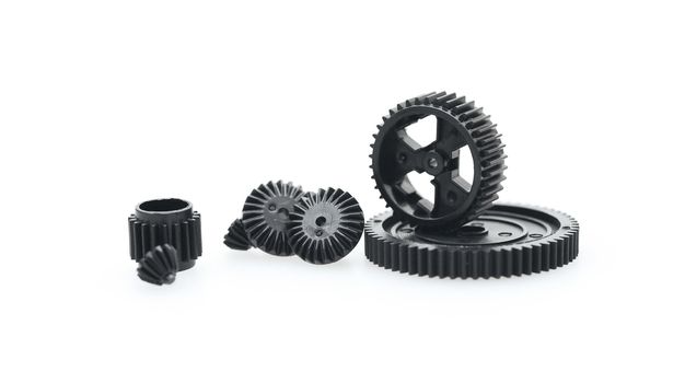 Black metal gear wheels of the different size on a white background