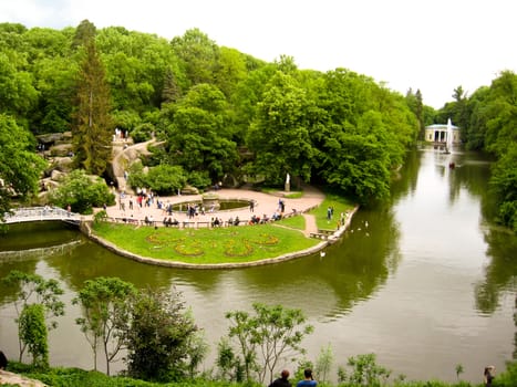 Beautiful city park with bushes, trees and lake