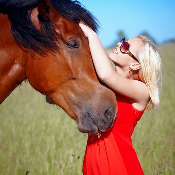 Portrait of the girl embracing a horse