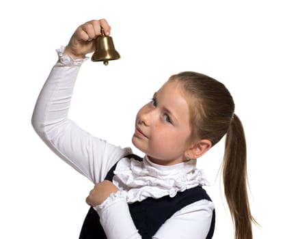 Young school girl ringing a golden bell on white background