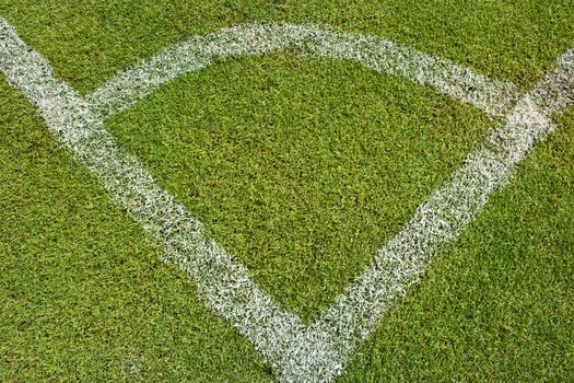 Corner of a football (soccer) field is made from synthetic lawn