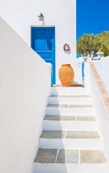 Staircase leading to an entrance with ceramic vase from the beautiful island of Sifnos, Greece
