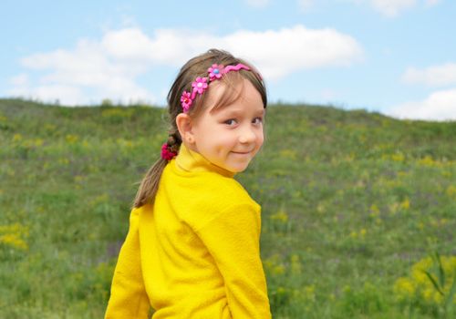 The Child on background of the nature, blue sky.