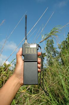 hand hold walky talky at field